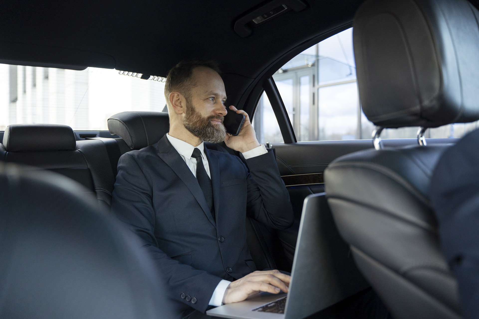 Business executive in luxury corporate vehicle