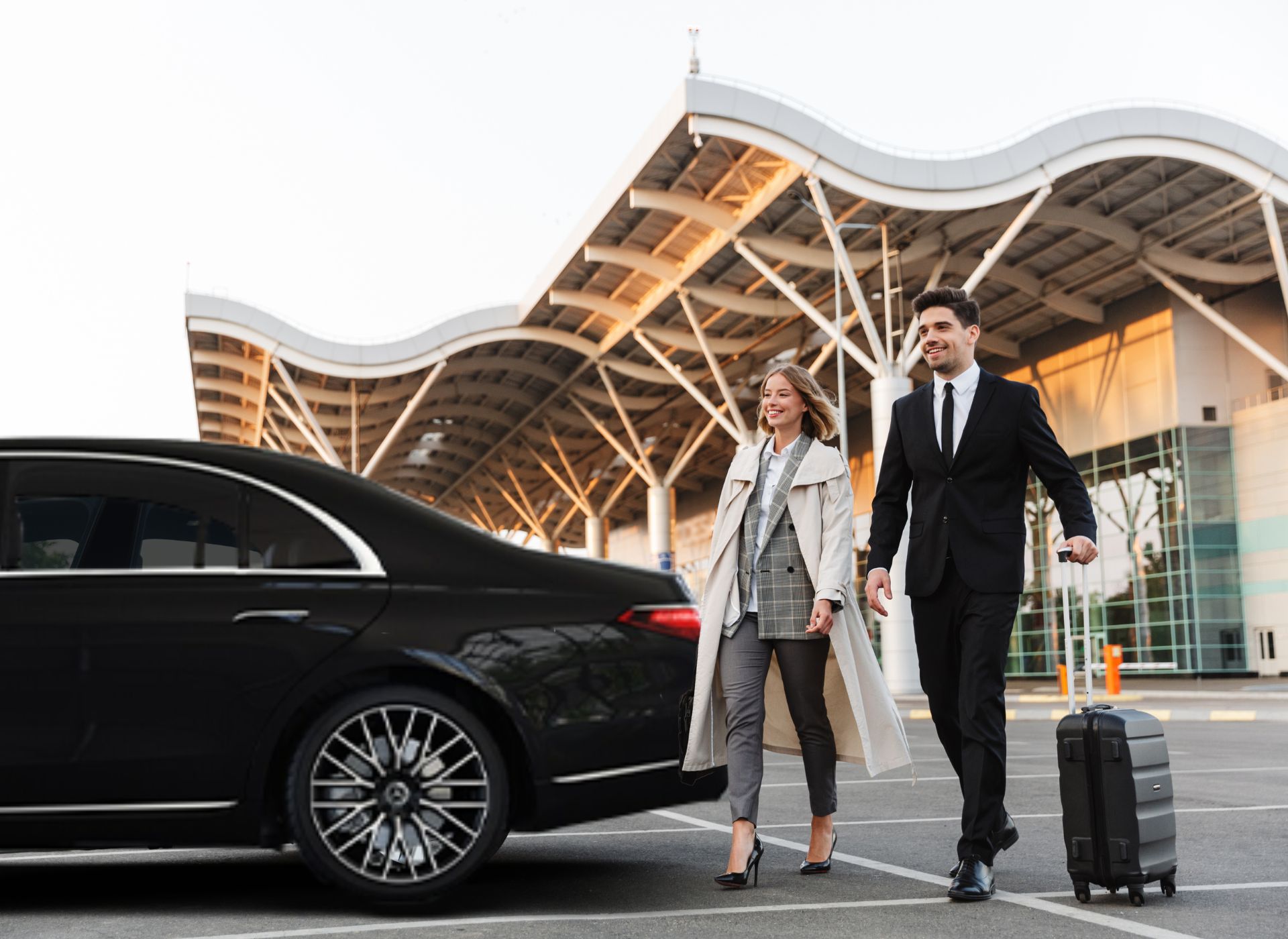 Luxury black sedan at airport terminal